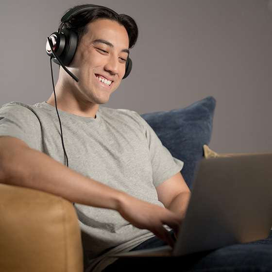 Man having a video conference wearing his H2000 headsets.