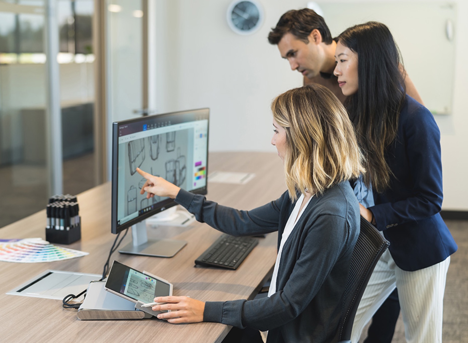 Women using a MS surface dock to get a desktop experience using a tablet and an external monitor.