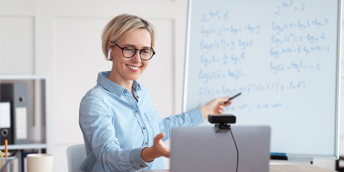 Woman presenting while looking at a Kensington webcam