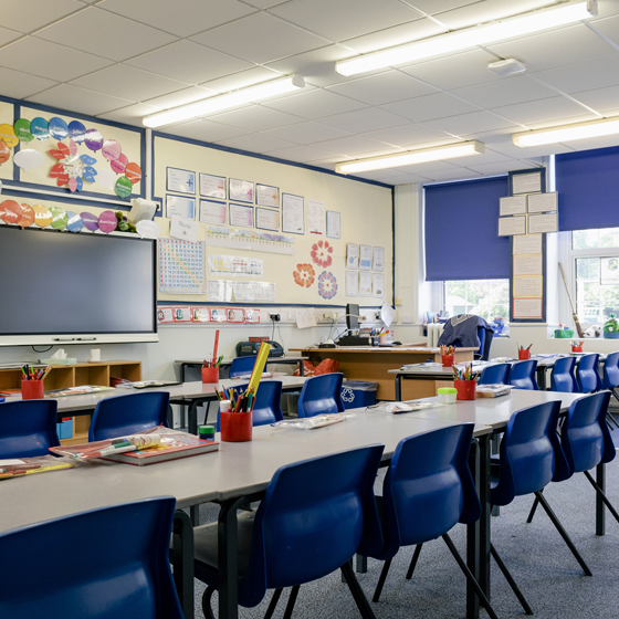 empty classroom with a whiteboard at the front of the room.